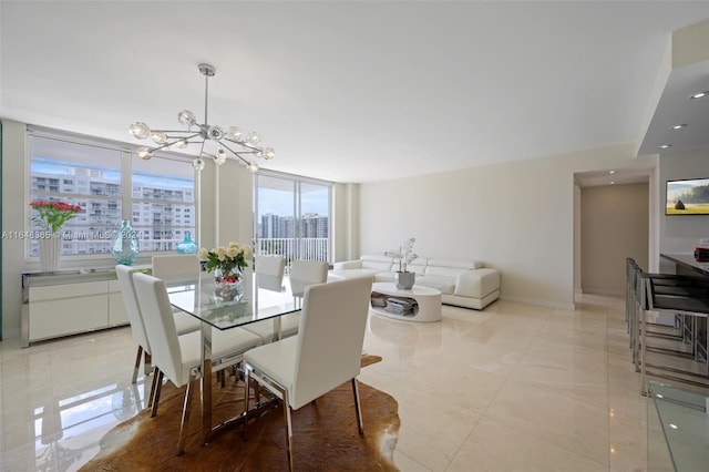 dining room featuring a notable chandelier and baseboards