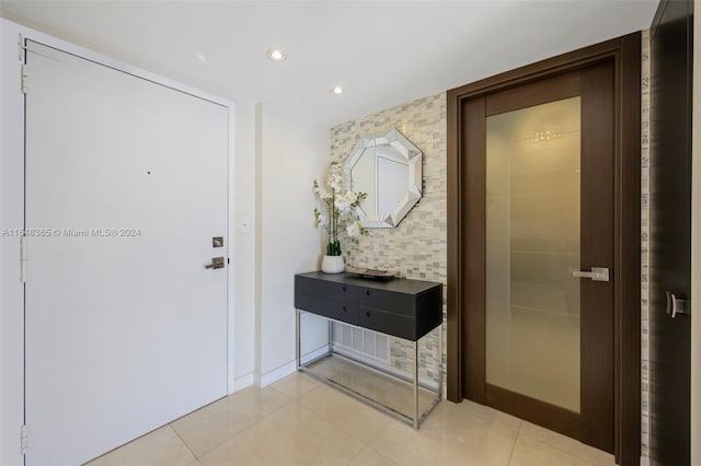 hall featuring light tile patterned floors and recessed lighting
