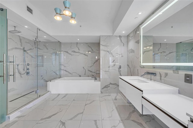 bathroom featuring vanity, independent shower and bath, and tile walls