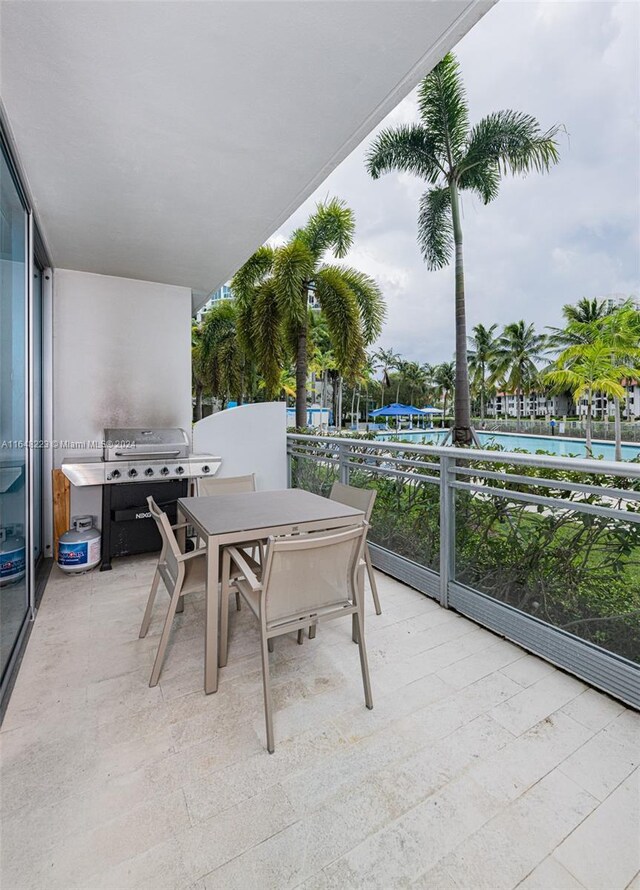 view of patio with a balcony and a grill