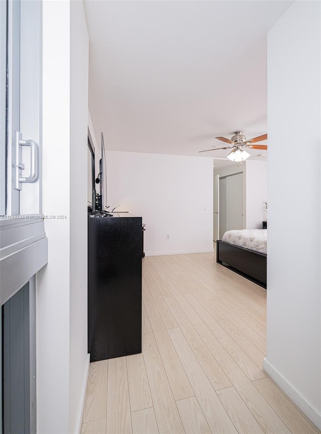 bedroom with ceiling fan and light hardwood / wood-style flooring