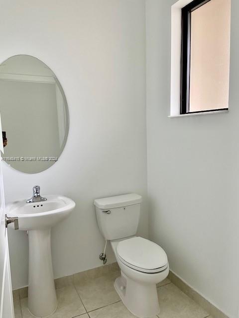 bathroom with tile patterned flooring and toilet