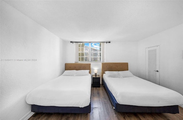 bedroom with dark wood-type flooring