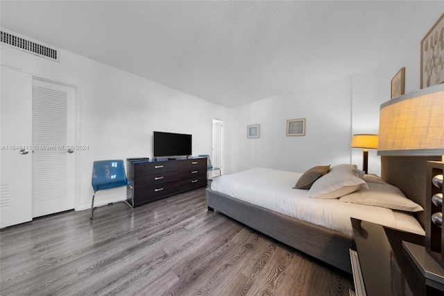 bedroom with hardwood / wood-style flooring