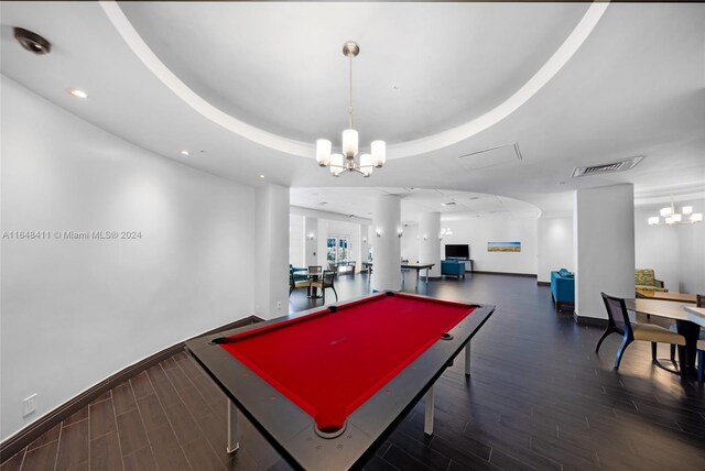 rec room featuring dark hardwood / wood-style floors, a raised ceiling, pool table, and a chandelier