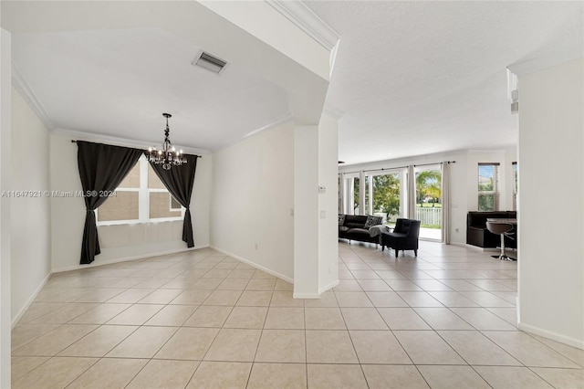 tiled spare room featuring a notable chandelier and ornamental molding