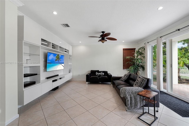 tiled living room featuring a textured ceiling, crown molding, built in shelves, and ceiling fan