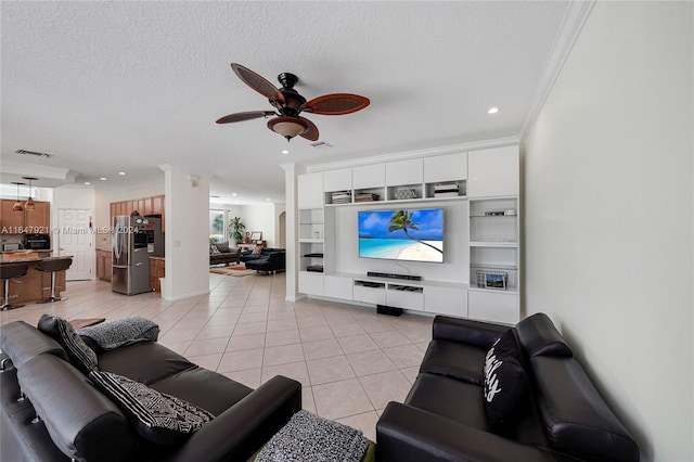 tiled living room with a textured ceiling, ceiling fan, and crown molding