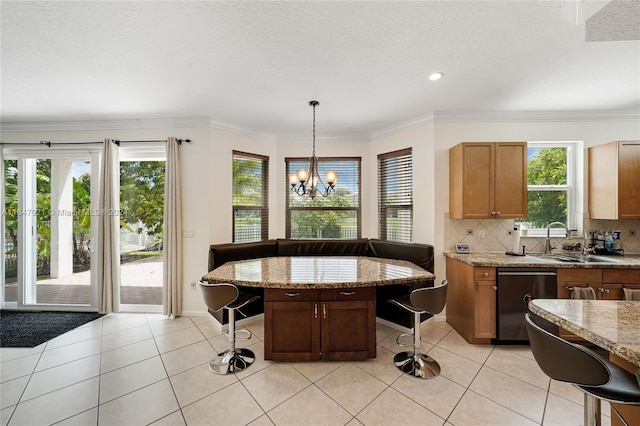 kitchen featuring a kitchen island, decorative light fixtures, dishwasher, a notable chandelier, and a kitchen bar