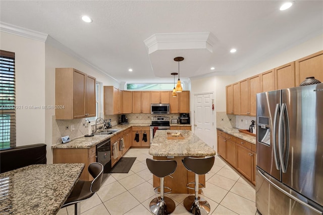 kitchen with sink, a kitchen island, stainless steel appliances, decorative light fixtures, and ornamental molding