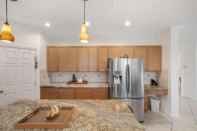 kitchen featuring hanging light fixtures, stainless steel fridge, light tile patterned flooring, backsplash, and ornamental molding