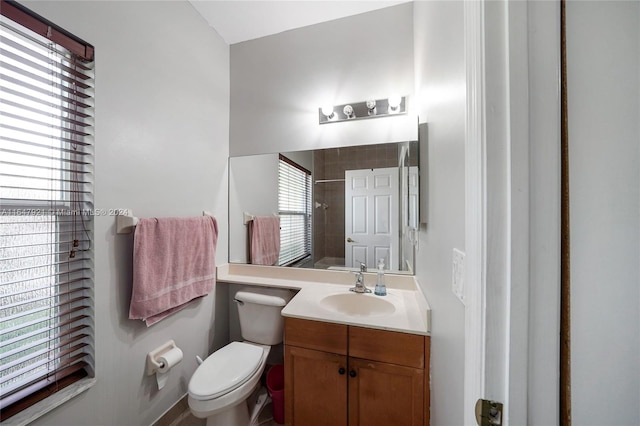 bathroom with curtained shower, vanity, and toilet