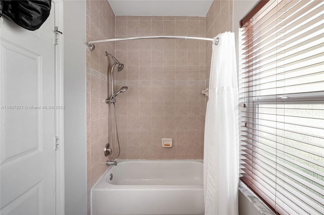 bathroom featuring shower / bath combination with curtain and a healthy amount of sunlight