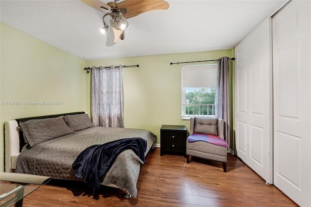 bedroom with hardwood / wood-style floors, ceiling fan, and a closet