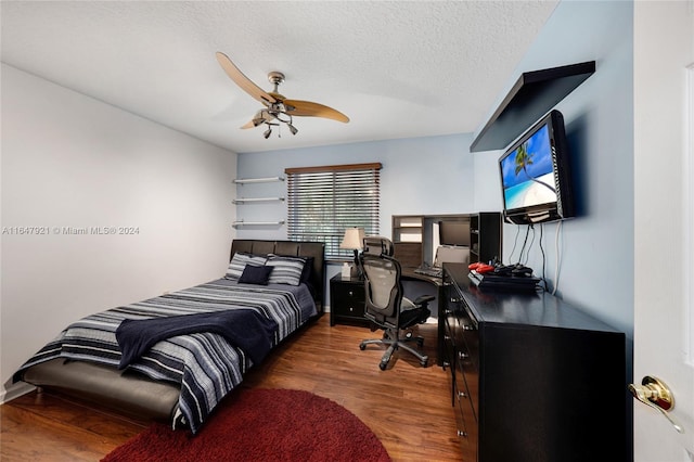 bedroom featuring a textured ceiling, dark hardwood / wood-style flooring, and ceiling fan