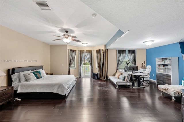 bedroom featuring ceiling fan, access to outside, dark wood-type flooring, and a textured ceiling