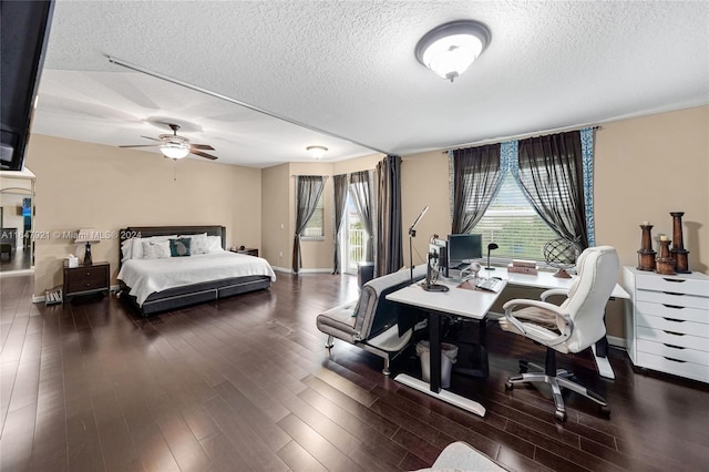 bedroom with ceiling fan, hardwood / wood-style flooring, and a textured ceiling