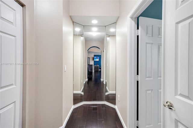 hallway with dark hardwood / wood-style flooring