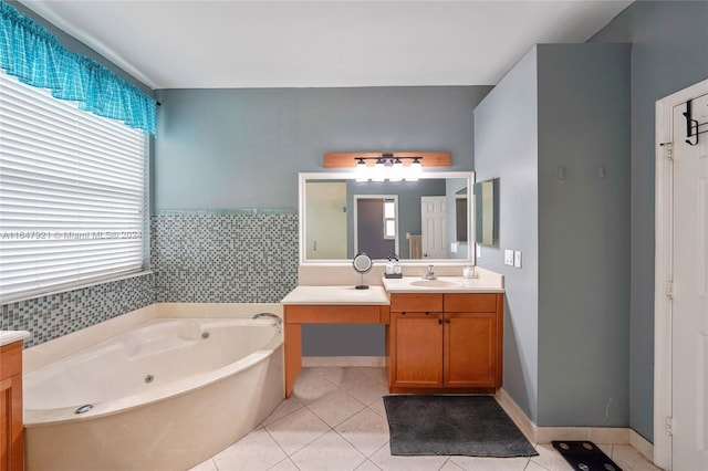 bathroom with decorative backsplash, tile patterned flooring, a bath, and vanity