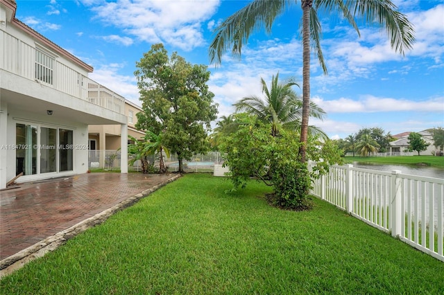 view of yard with a patio and a water view