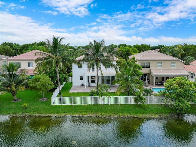 back of property featuring a patio, a water view, a fenced in pool, and a yard