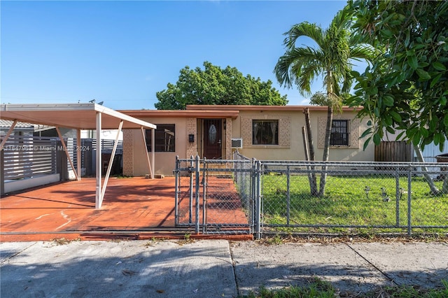 view of front of property featuring a carport and a front lawn