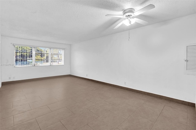 tiled empty room with a textured ceiling and ceiling fan