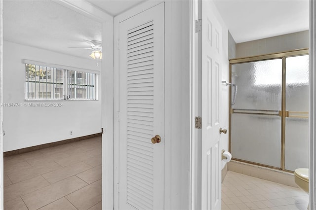 bathroom featuring tile patterned floors, toilet, walk in shower, and ceiling fan