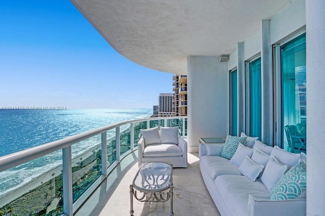 balcony with outdoor lounge area and a water view