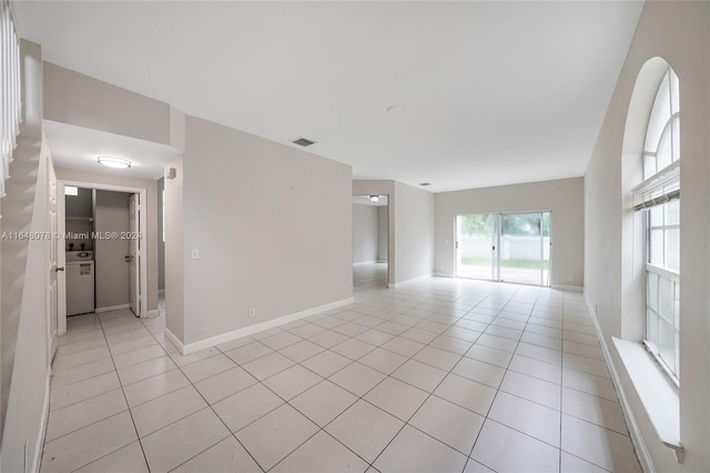 spare room featuring light tile patterned floors and washer / clothes dryer