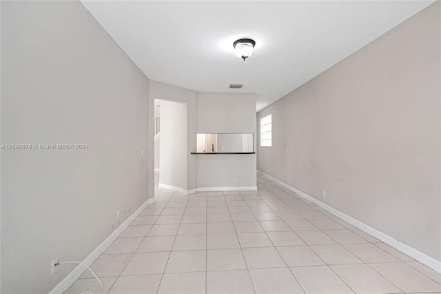 unfurnished room featuring light tile patterned flooring