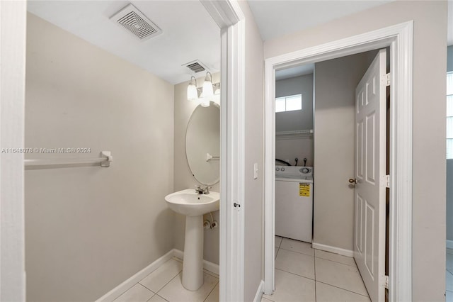 bathroom featuring washer / dryer and tile patterned floors