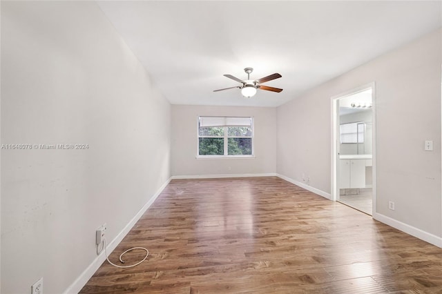 spare room featuring hardwood / wood-style floors and ceiling fan