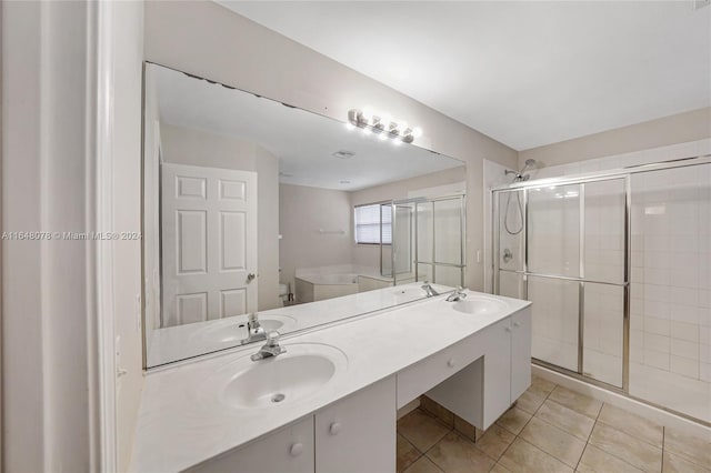 bathroom featuring vanity, plus walk in shower, and tile patterned floors