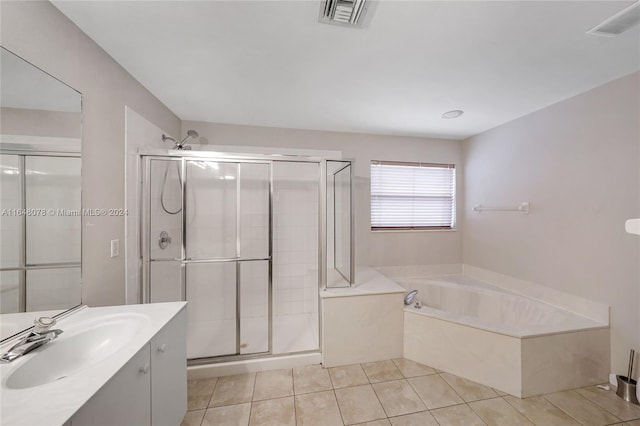 bathroom with tile patterned flooring, separate shower and tub, and vanity