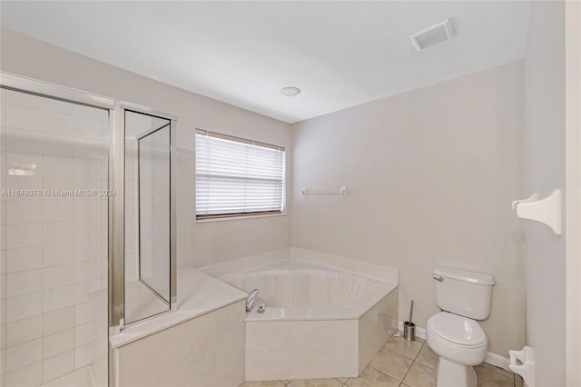 bathroom featuring tile patterned flooring, toilet, and shower with separate bathtub