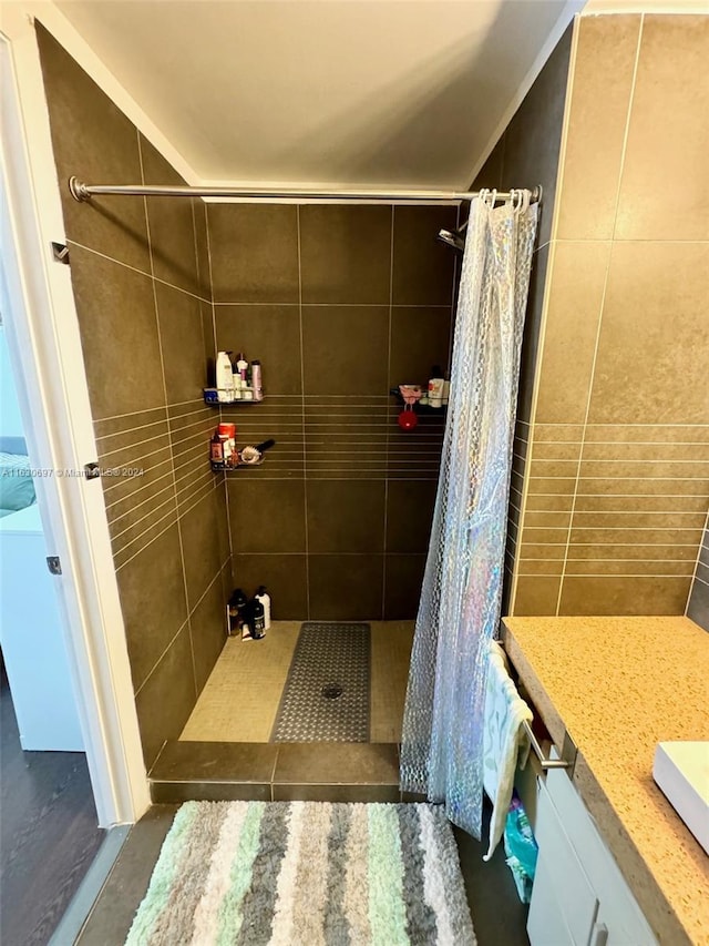 bathroom with curtained shower, tile patterned flooring, and vanity