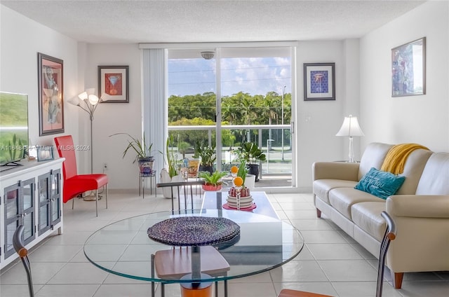 sitting room with a textured ceiling, light tile patterned flooring, and a healthy amount of sunlight