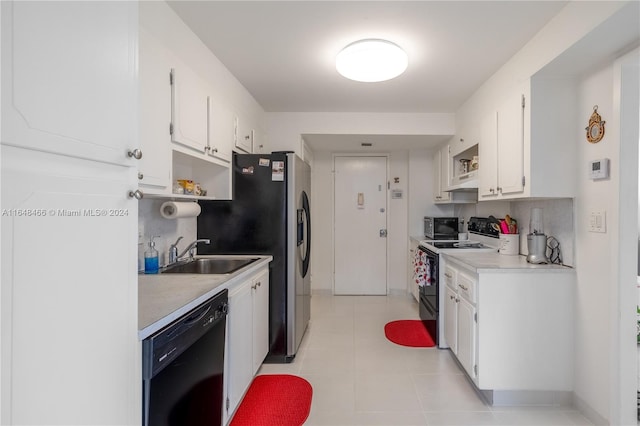 kitchen featuring white cabinetry, electric range, light tile patterned flooring, and black dishwasher