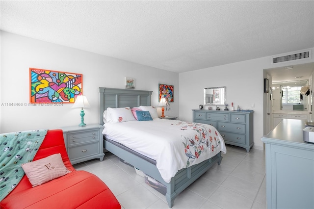 tiled bedroom featuring a textured ceiling