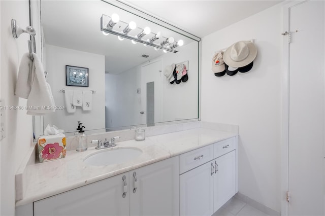 bathroom with tile patterned flooring and vanity