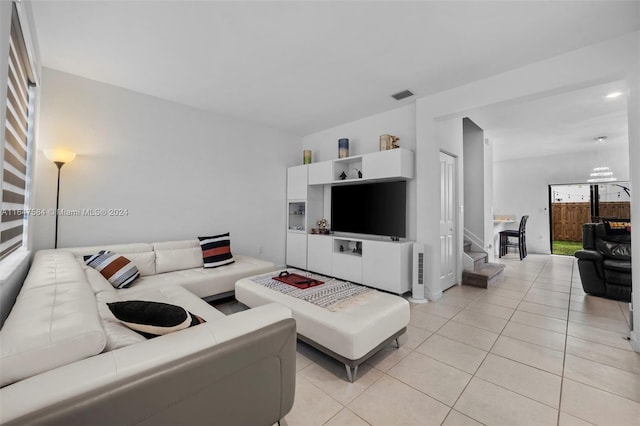 living room featuring light tile patterned flooring and visible vents