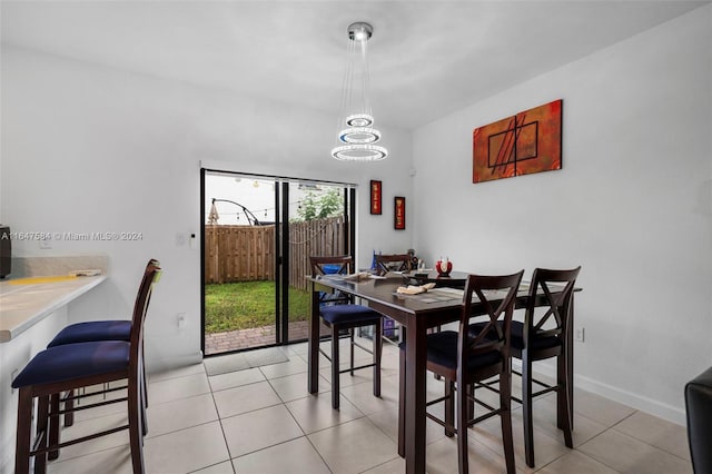 tiled dining area with a notable chandelier