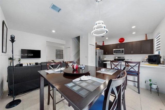 dining space featuring stairway, light tile patterned flooring, visible vents, and recessed lighting
