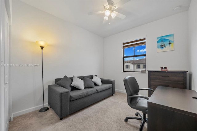 office with ceiling fan, baseboards, and light carpet