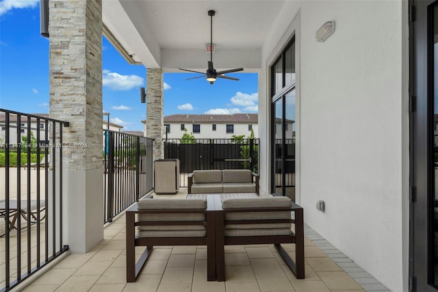 balcony featuring an outdoor living space and ceiling fan