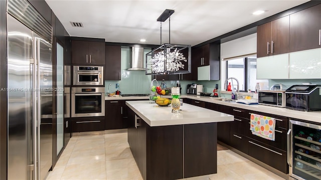 8886 NW 187th St, Miami, FL 33018 - kitchen with appliances with stainless steel finishes, light countertops, wall chimney exhaust hood, wine cooler, and a sink
