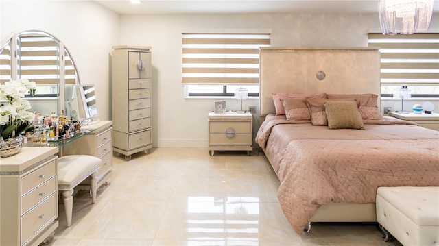 8886 NW 187th St, Miami, FL 33018 - bedroom featuring light tile patterned floors, baseboards, and a notable chandelier