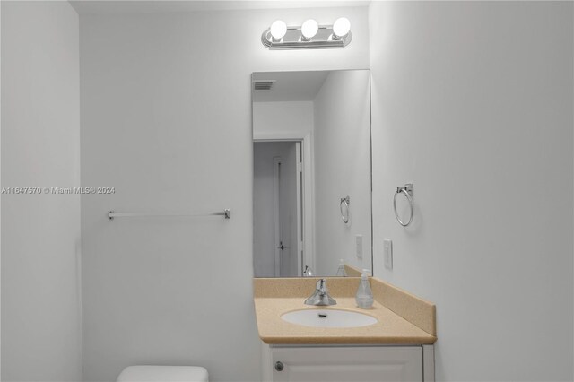 bathroom with vanity and toilet