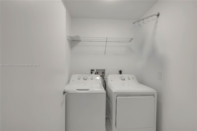 clothes washing area featuring washer and clothes dryer